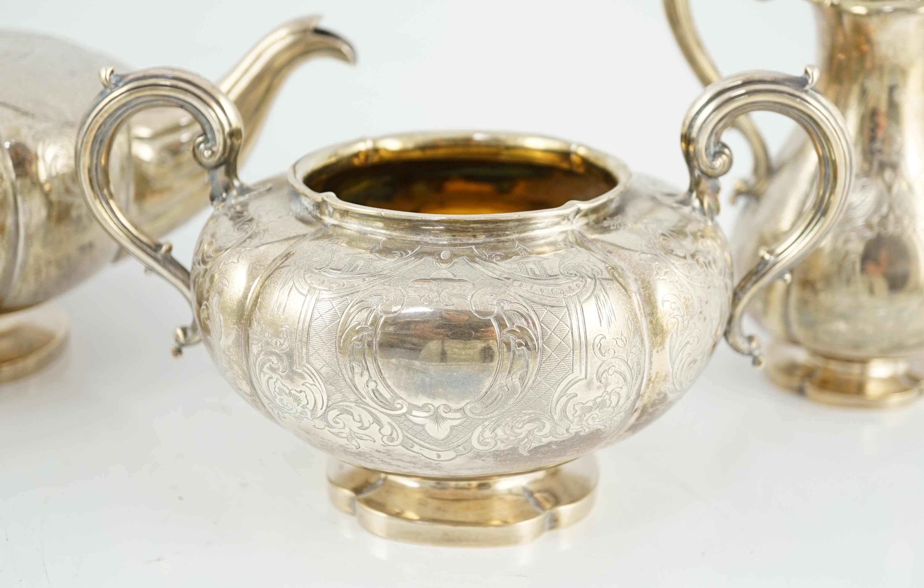 A Victorian silver three piece melon shaped tea set, by Charles Reily & George Storer